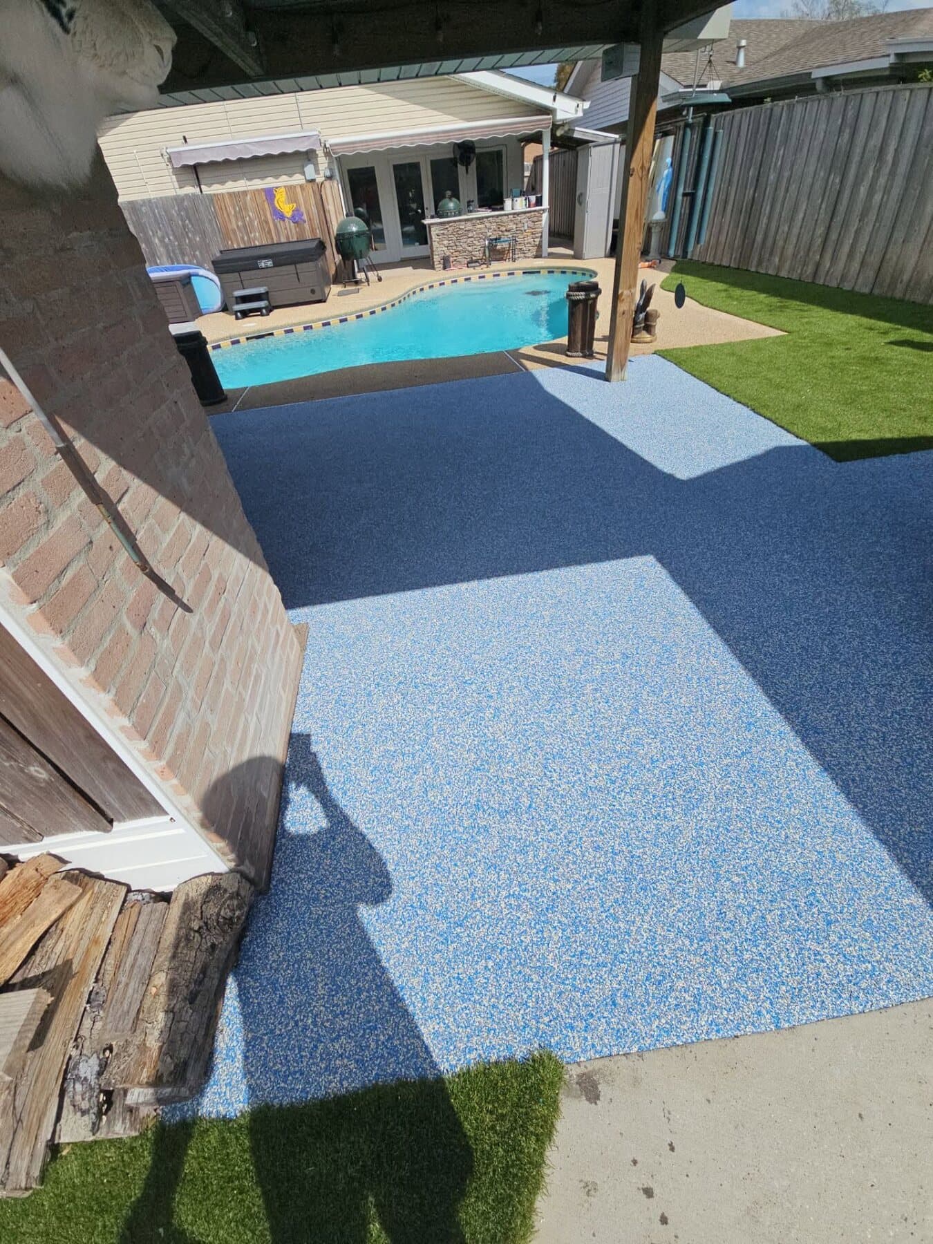 Finished blue Caspian pool deck at a Northwest Arkansas home