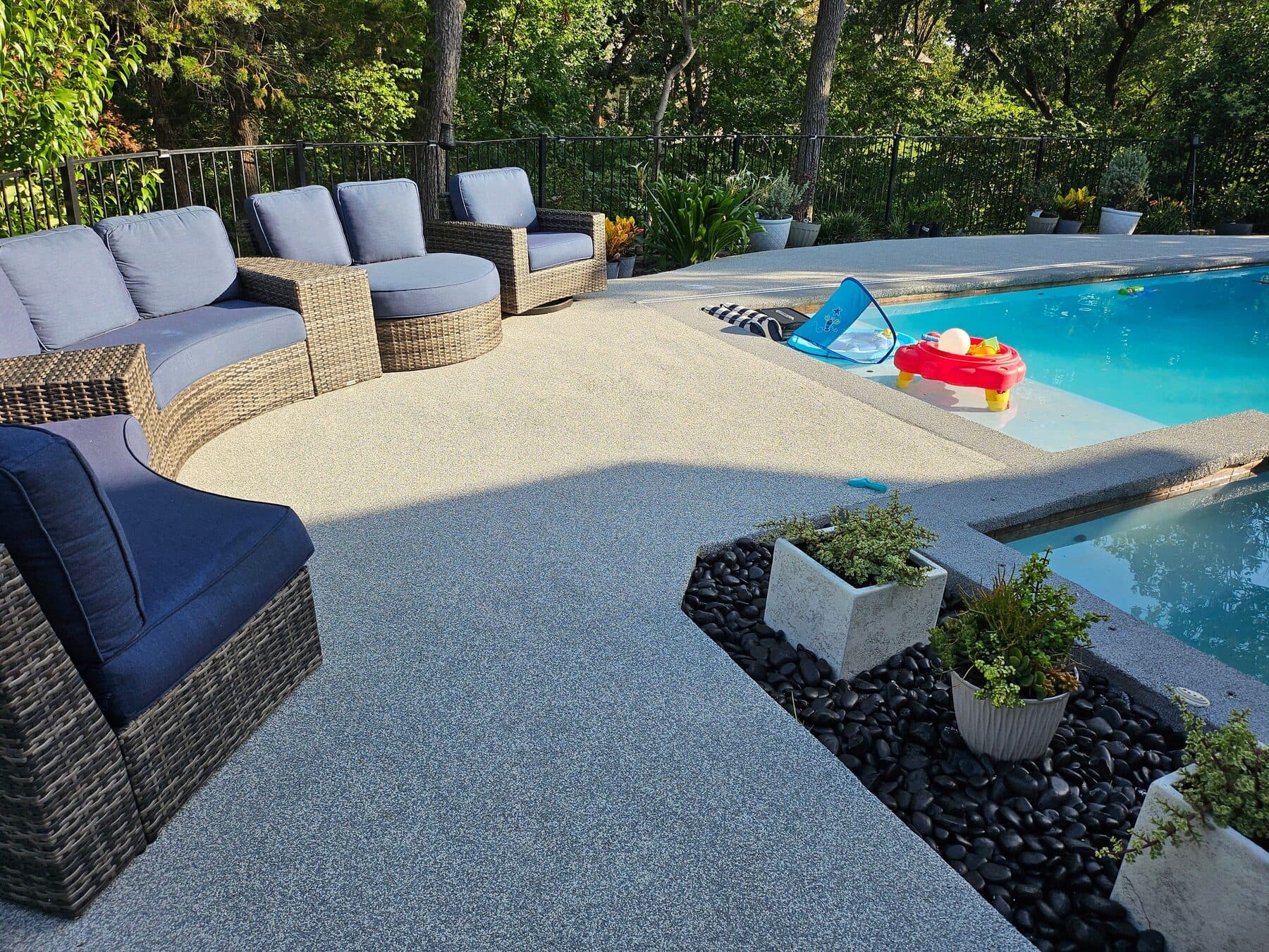 Finished cool neutral pool deck with outdoor lounge seating