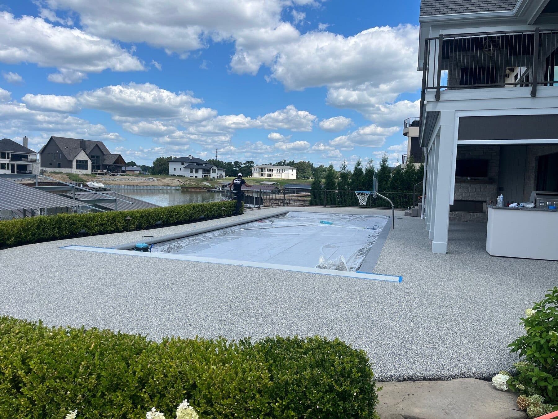 Finished Nickel pool deck surrounding a large backyard pool