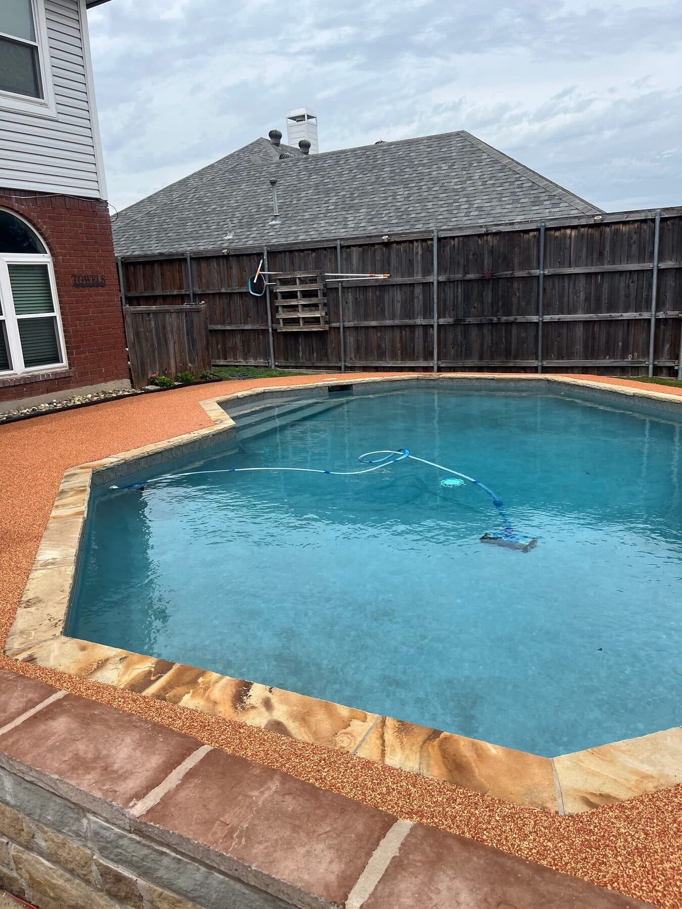Finished Santa Fe deck surrounding a backyard pool