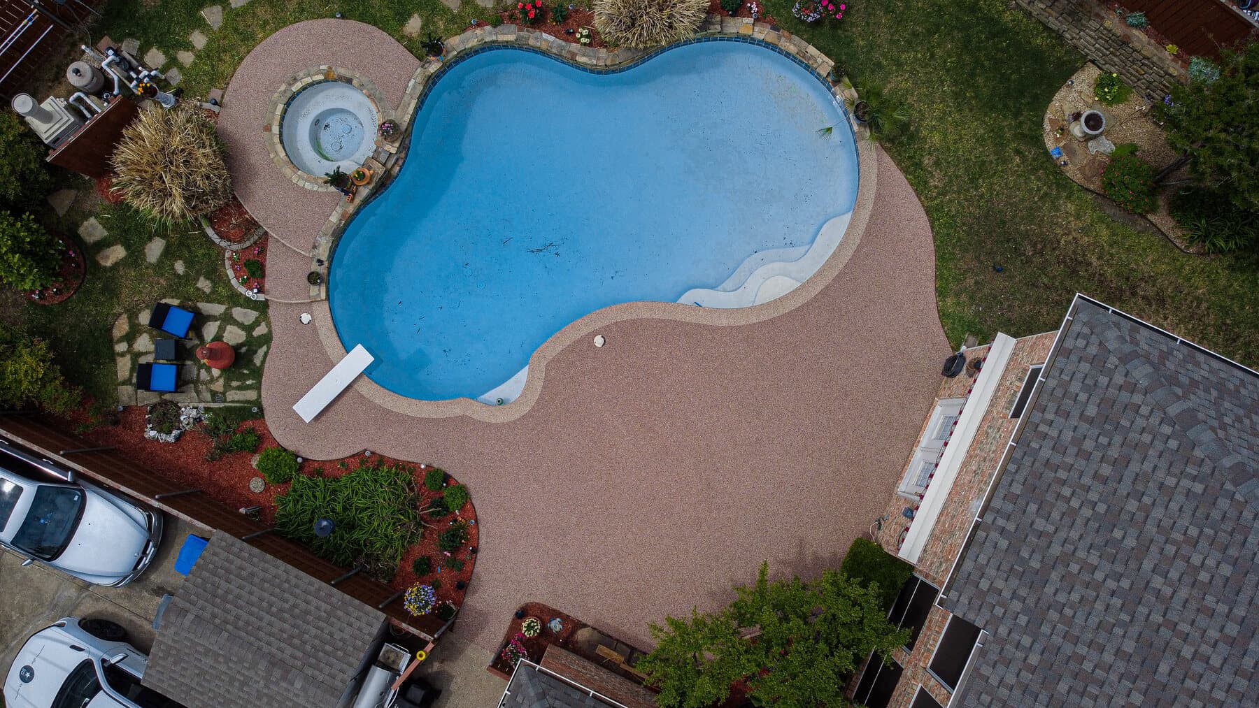 Aerial view of a curved Rubaroc pool deck installation