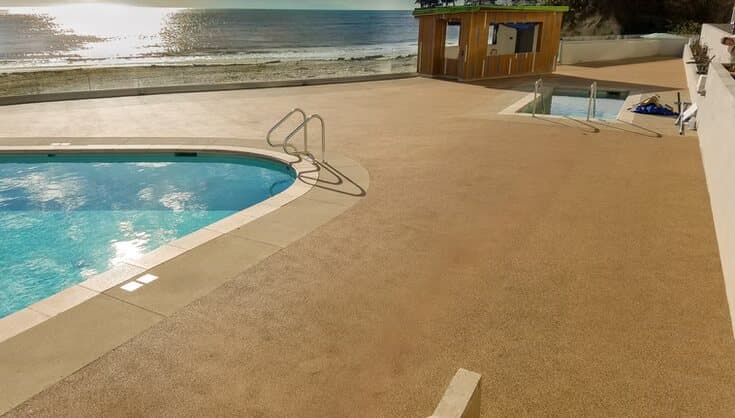 Light Rubaroc pool deck overlooking a beachfront setting