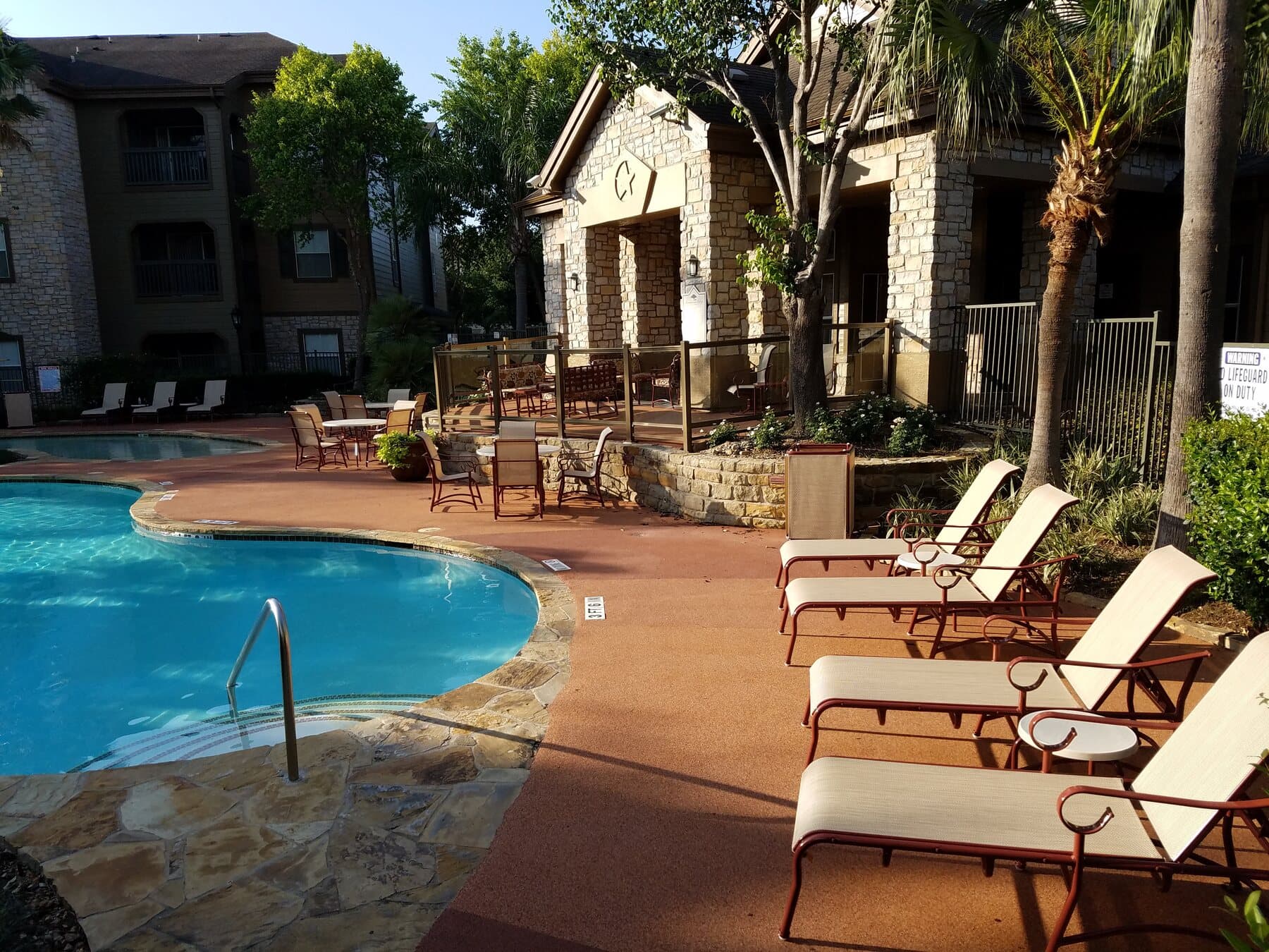 Rubaroc pool deck installation with lounge seating and landscaping