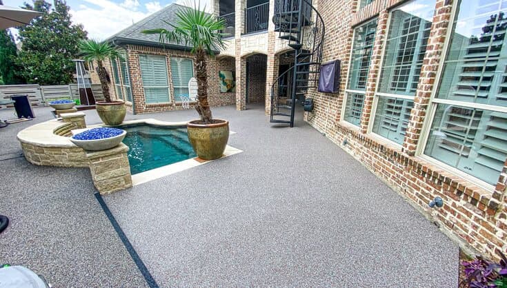 Gray Rubaroc pool deck in a landscaped residential courtyard
