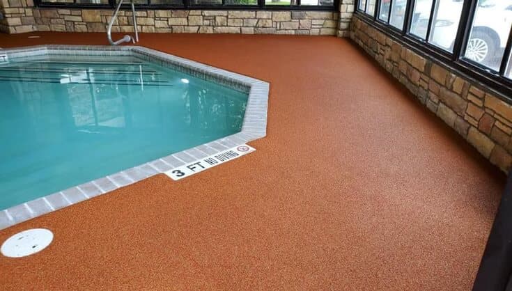 Indoor Rubaroc pool deck finished in a bold coral tone