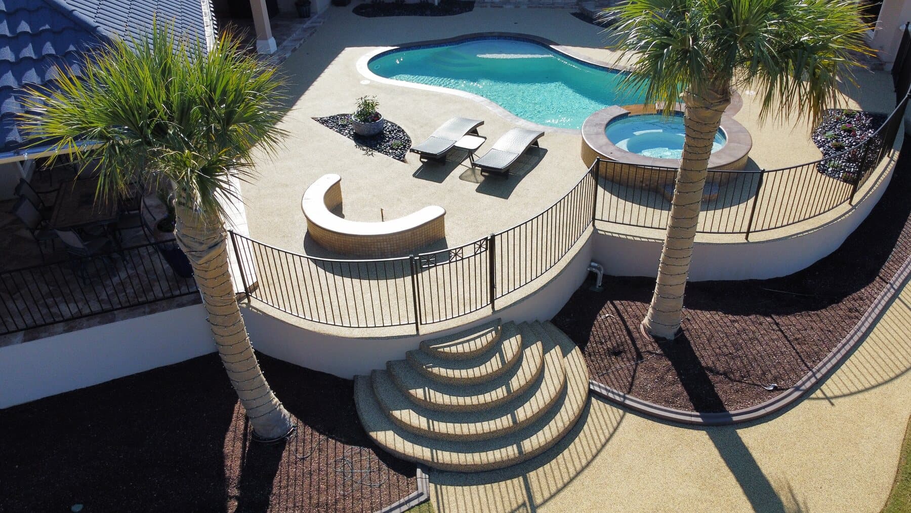 Elevated backyard pool finished with a light Rubaroc surface