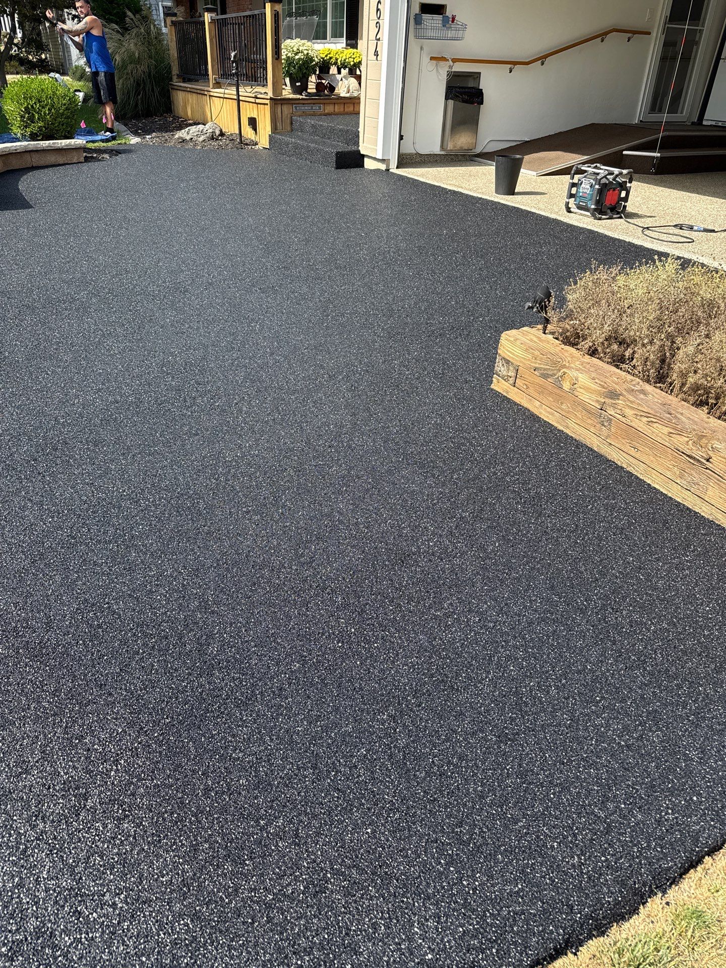 Concrete coating vs pavers vs stamped concrete comparison — hand-troweled rubber-coated surface in Little Rock, Arkansas