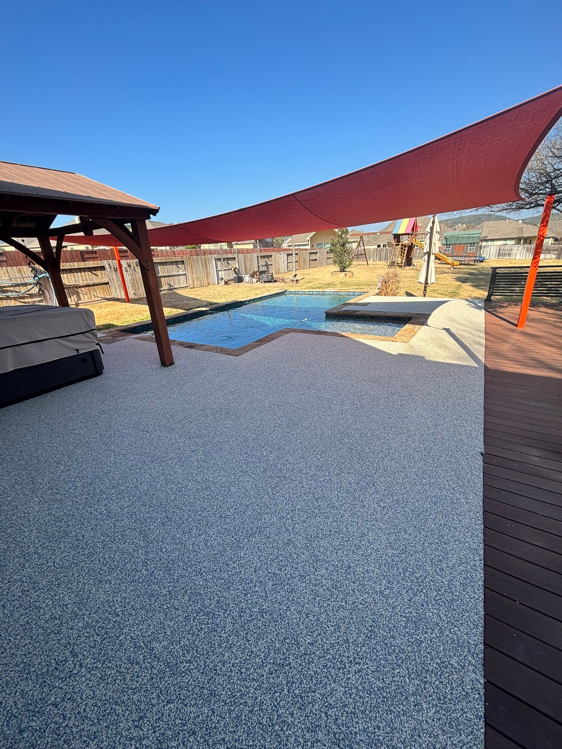 Pool deck resurfacing in Little Rock with a hand-troweled EPDM rubber finish around the water's edge