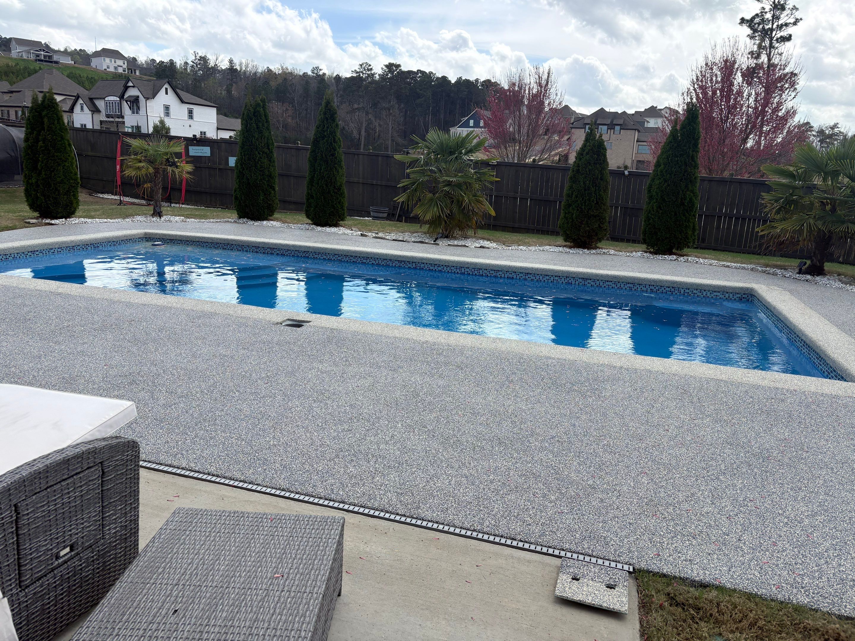 Kool Deck alternative in Little Rock with a hand-troweled rubber pool deck finish around a backyard pool
