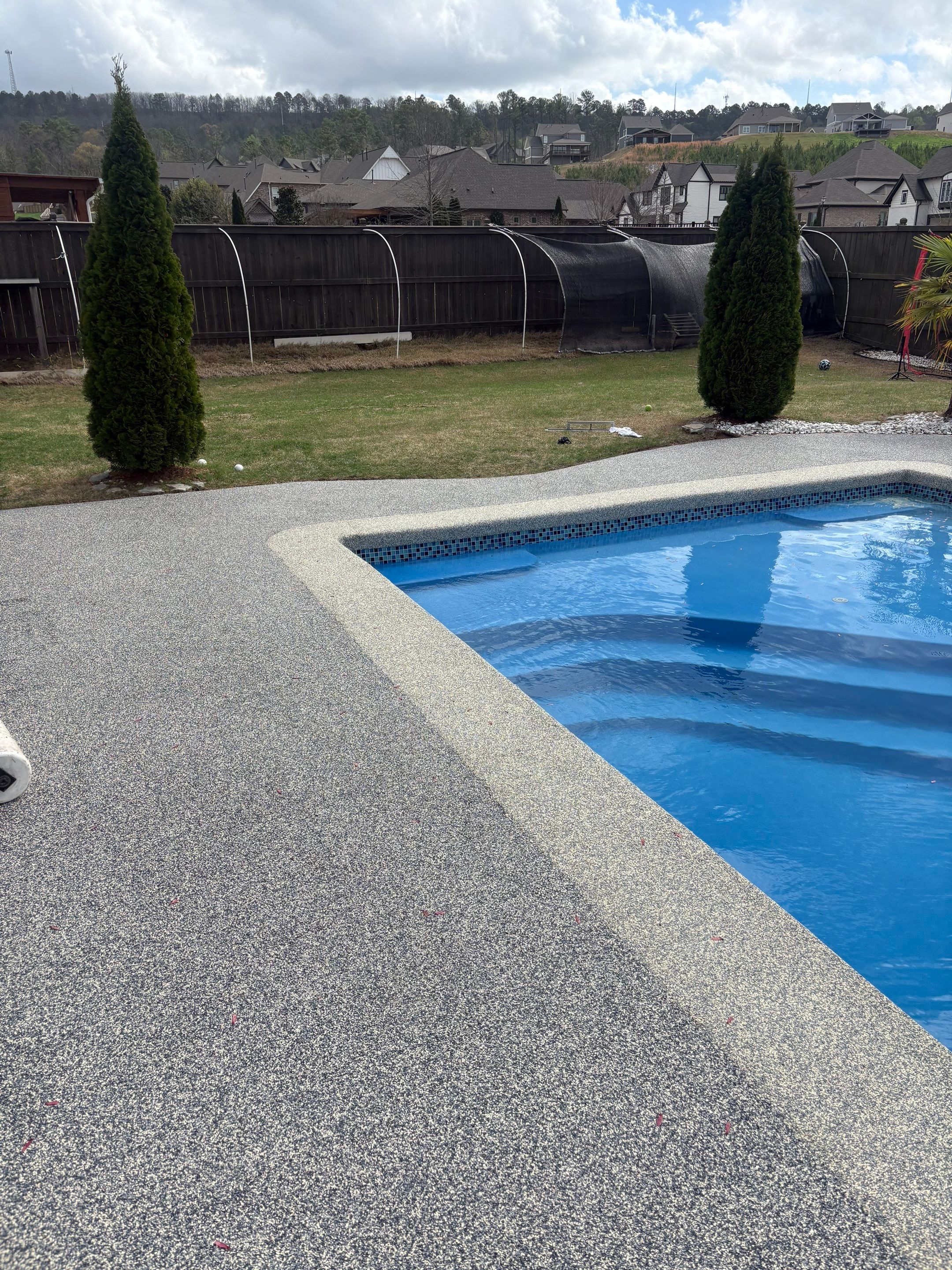 Rubber pool deck vs epoxy comparison on a Little Rock pool deck with Fox's hand-troweled EPDM rubber finish