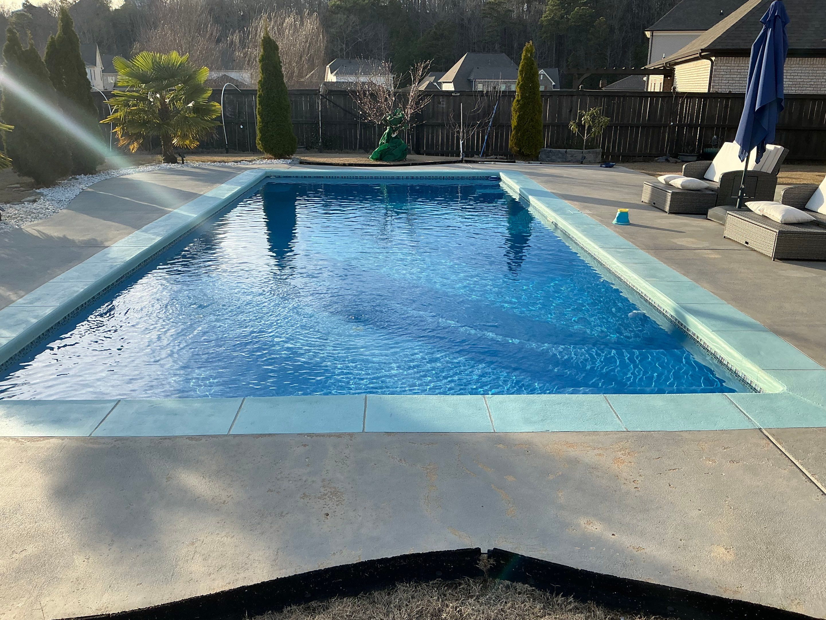 Worn concrete before pool deck resurfacing Bartlett TN with a hand-troweled rubber surface